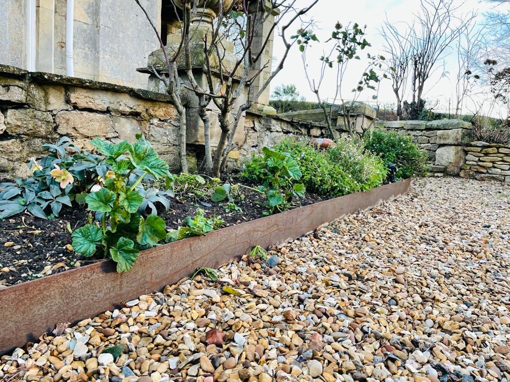 Steel Gravel Edging separating flower bed and path