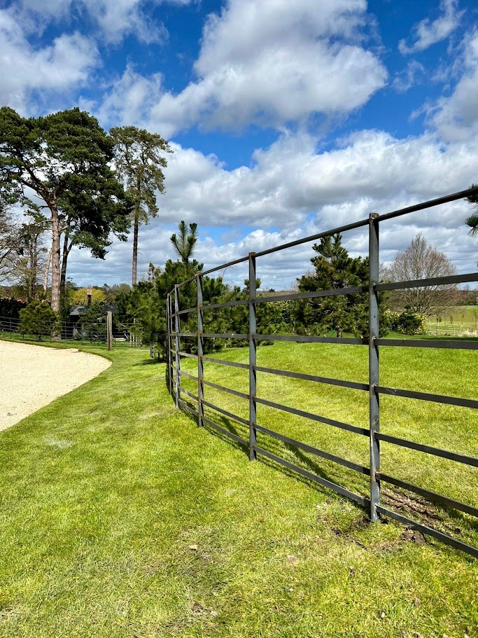 Estate fencing running along driveway.
