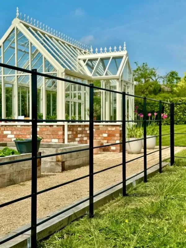 Estate Fencing running past a greenhouse
